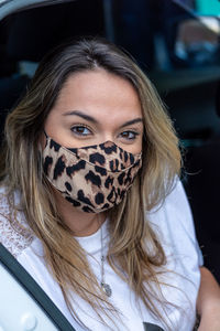 Portrait of beautiful woman sitting in car