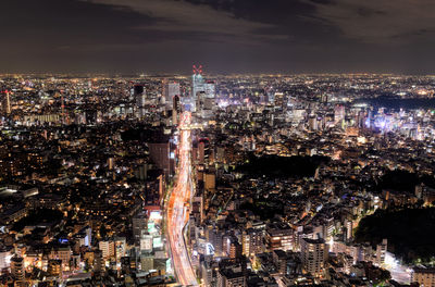 High angle view of city lit up at night