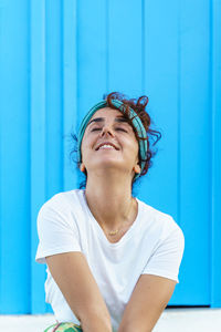 Portrait of beautiful tanned woman on holidays. isolated woman on blue background. happiness concept