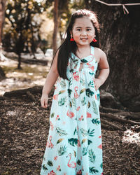 Portrait of smiling girl standing in forest