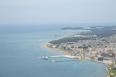 High angle view of sea and cityscape against sky