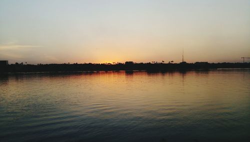 Scenic view of silhouette beach against sky during sunset