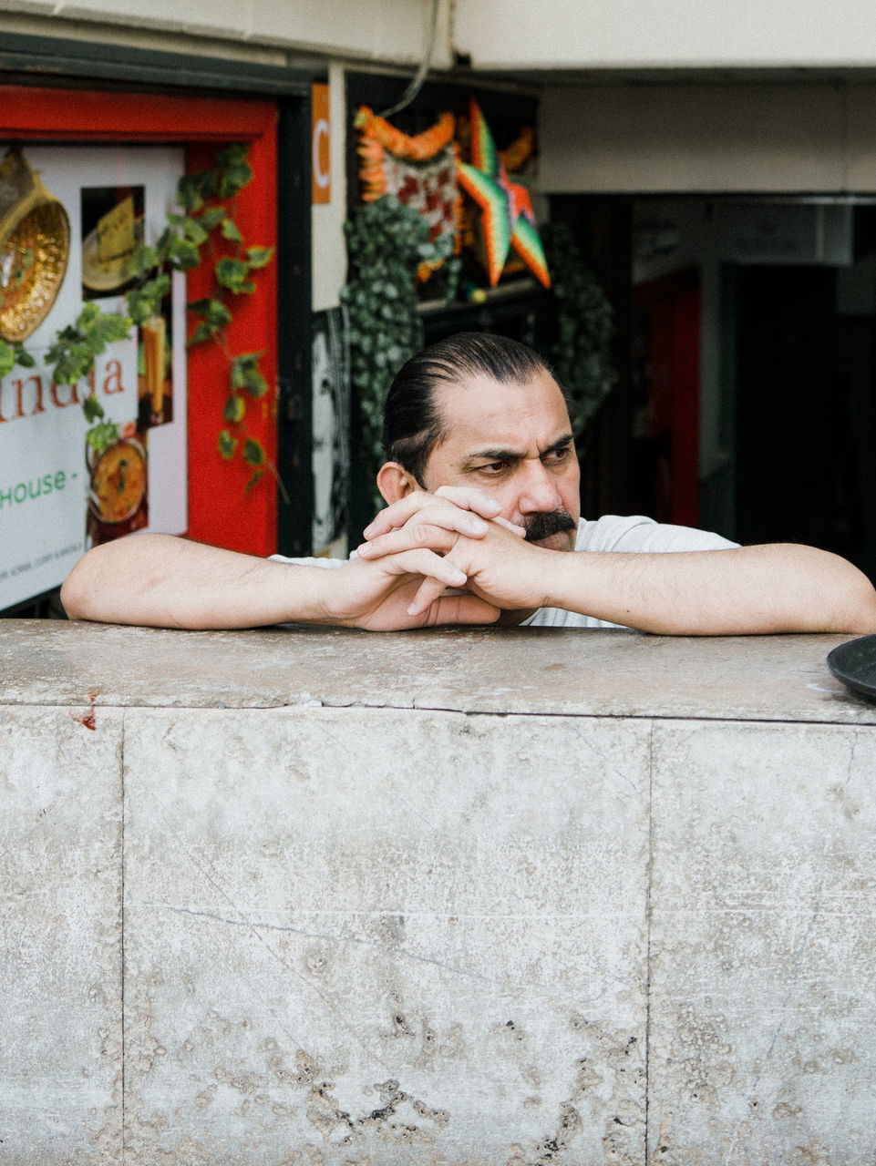 portrait, one person, architecture, young adult, front view, real people, lifestyles, headshot, young men, looking at camera, built structure, leisure activity, casual clothing, building exterior, hand, day, human hand, teenager, contemplation, depression - sadness, human face