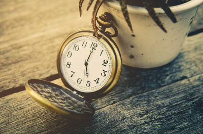 Close-up of pocket clock on table