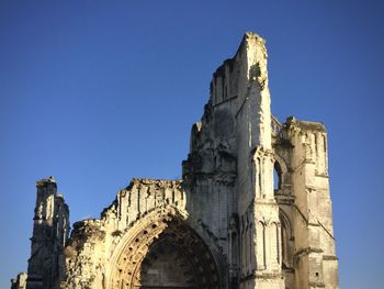 Low angle view of historical building against clear blue sky