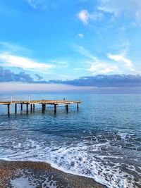 Pier on sea against sky