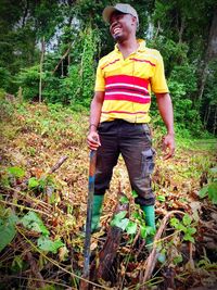 Full length of boy standing in forest