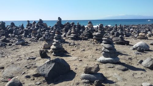 Panoramic view of pebbles on beach against sky