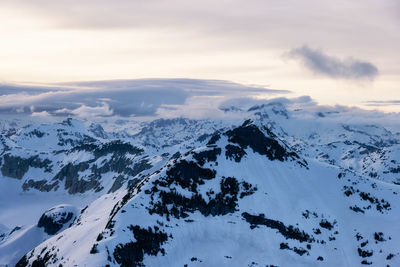 Scenic view of snow covered mountains against sky