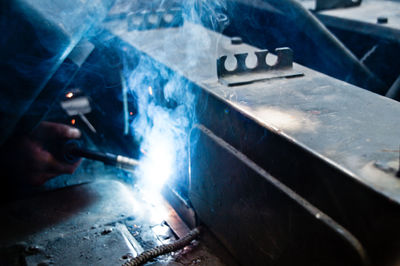 Close-up of man working on metal