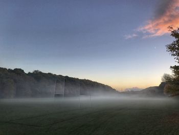 Misty landscape against blue sky