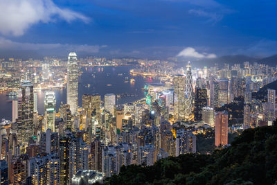 High angle view of illuminated cityscape against sky at night