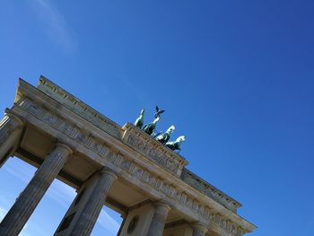 Low angle view of historical building against blue sky