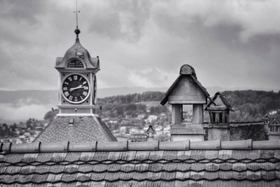 View of church and building against cloudy sky