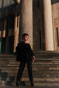 Rear view of woman walking on steps