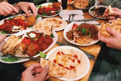 High angle view of friends eating lunch at restaurant