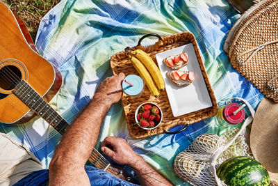 Summertime healthy picnic. fresh tropical fruit, sweet stawberry sandwiches and refreshing drink