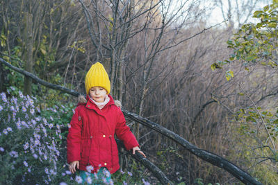 Portrait of young woman standing in forest