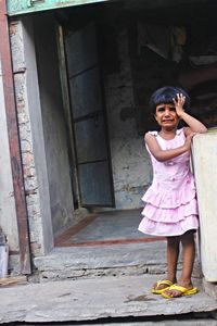 Portrait of smiling girl standing at night