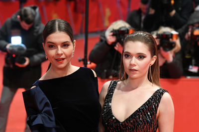 Portrait of young woman and friends at night