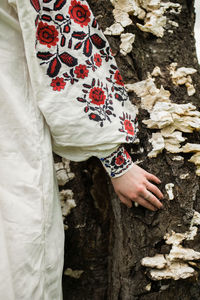 Midsection of woman standing on rock