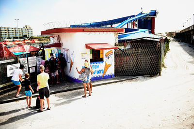 People on beach against clear sky