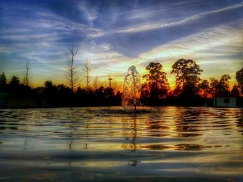 Scenic view of lake against sky during sunset