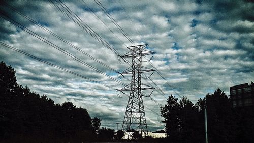 Low angle view of electricity pylon against sky