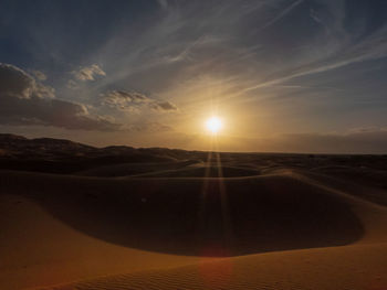 Scenic view of desert against sky during sunset