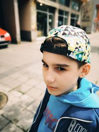 Close-up portrait of boy in city