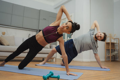 Full length of woman exercising in gym