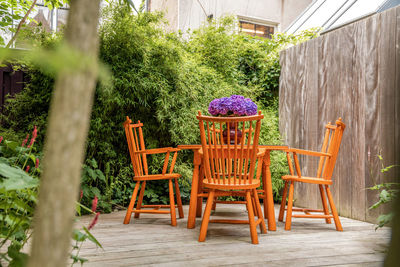 Empty chairs and tables in yard