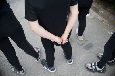 Low section of people standing on street