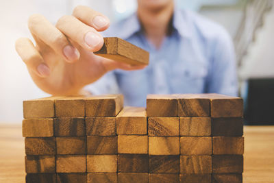 Midsection of woman holding ice cream on wooden table