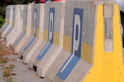 Blue and white car parking sign on a concrete block