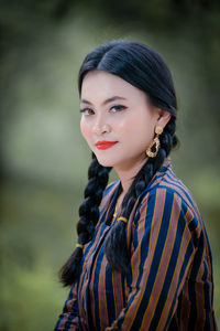 Portrait of young woman standing outdoors