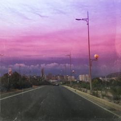 Empty road against cloudy sky