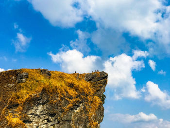 Low angle view of rocky mountain against sky