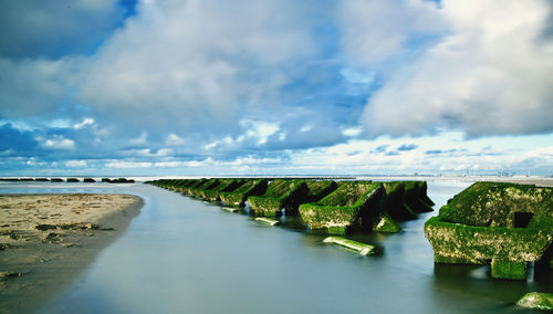 Bridge over sea against sky