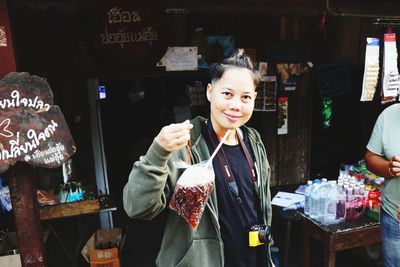 Portrait of woman standing at market stall