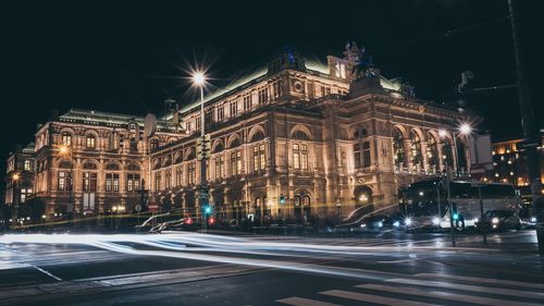 Illuminated city street at night
