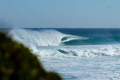 Scenic view of sea waves against sky