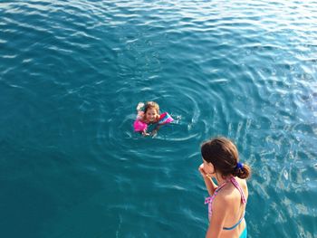 High angle view of people swimming in sea