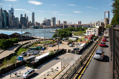 High angle view of traffic on road by buildings against sky