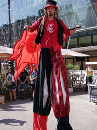 Midsection of woman with red umbrella