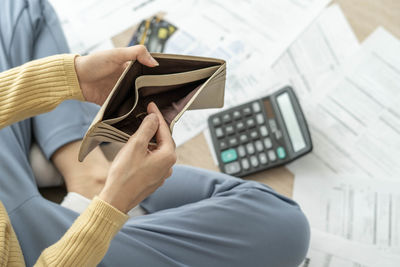 Midsection of man holding camera on table