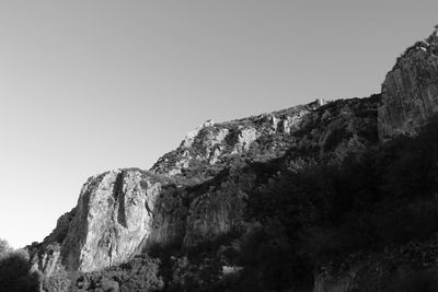 Low angle view of rock formation against clear sky