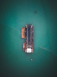 High angle view of carrier ship floating on sea