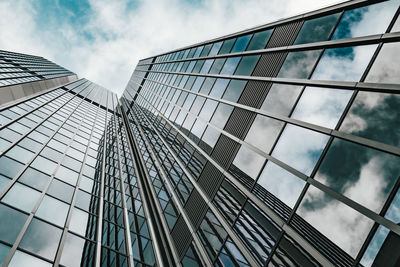 Low angle view of glass building against sky