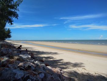 Scenic view of beach against blue sky